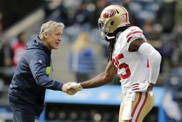 San Francisco 49ers cornerback Richard Sherman, right, shakes hands with Seattle Seahawks head coach Pete Carroll, left, before an NFL football game, Sunday, Dec. 2, 2018, in Seattle. (AP Photo/John Froschauer)