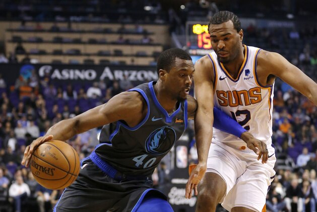Dallas Mavericks forward Harrison Barnes drives on Phoenix Suns forward T.J. Warren (12) in the first half during an NBA basketball game, Thursday, Dec. 13, 2018, in Phoenix. (AP Photo/Rick Scuteri)