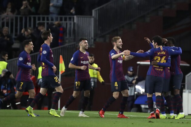 Barcelona forward Ousmane Dembele, right, celebrates after scoring the opening goal during the Champions League group B soccer match between FC Barcelona and Tottenham Hotspur at the Camp Nou stadium in Barcelona, Spain, Tuesday, Dec. 11, 2018. (AP Photo/Emilio Morenatti)