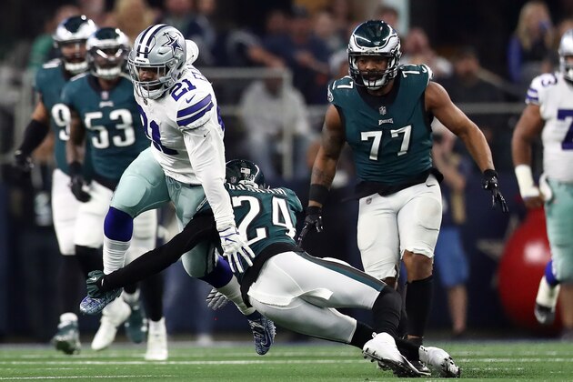 ARLINGTON, TEXAS - DECEMBER 09:  Ezekiel Elliott #21 of the Dallas Cowboys runs the ball against Corey Graham #24 of the Philadelphia Eagles in the second quarter at AT&T Stadium on December 09, 2018 in Arlington, Texas. (Photo by Ronald Martinez/Getty Images)