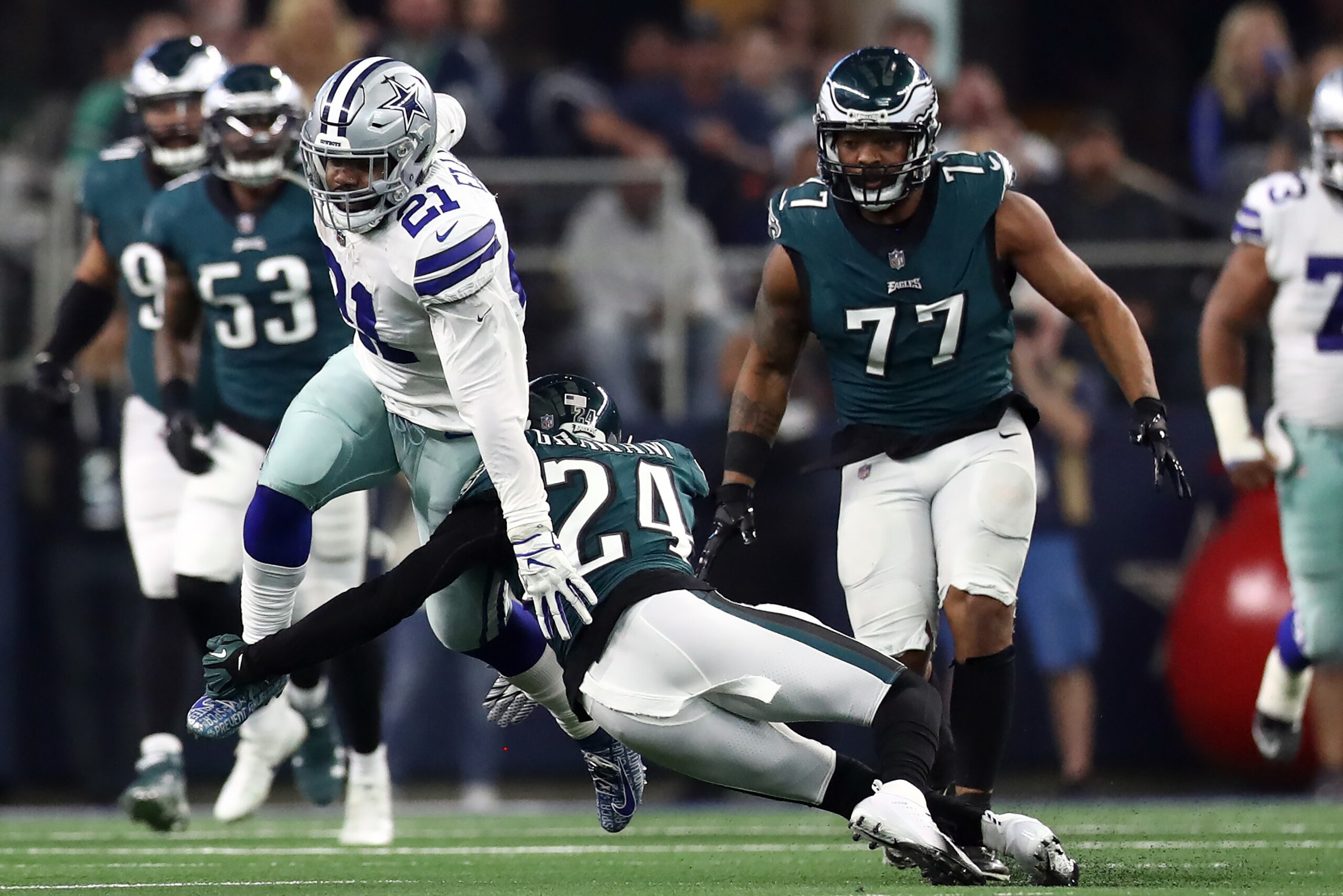 ARLINGTON, TEXAS - DECEMBER 09:  Ezekiel Elliott #21 of the Dallas Cowboys runs the ball against Corey Graham #24 of the Philadelphia Eagles in the second quarter at AT&T Stadium on December 09, 2018 in Arlington, Texas. (Photo by Ronald Martinez/Getty Images)