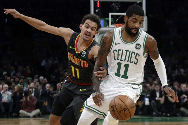 Boston Celtics guard Kyrie Irving, right, drives past Atlanta Hawks guard Trae Young, left, in the first quarter of an NBA basketball game, Friday, Dec. 14, 2018, in Boston. (AP Photo/Elise Amendola)