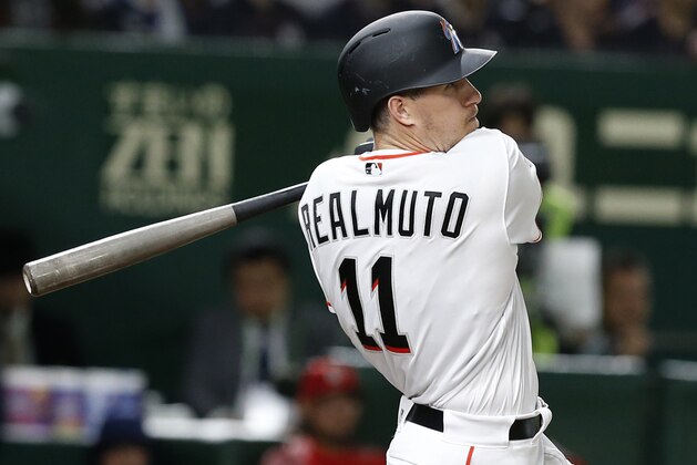 MLB All-Star catcher J.T. Realmuto of the Miami Marlins watches the flight of his three-run home-run off All Japan's pitcher Masaru Sato in the eighth inning of Game 2 of their All-Stars Series baseball at Tokyo Dome in Tokyo, Saturday, Nov. 10, 2018. (AP Photo/Toru Takahashi)