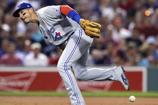 Toronto Blue Jays shortstop Troy Tulowitzki runs past the ball on an RBI single by Boston Red Sox's Dustin Pedroia during the fourth inning of a baseball game at Fenway Park in Boston, Wednesday, July 19, 2017. (AP Photo/Charles Krupa)