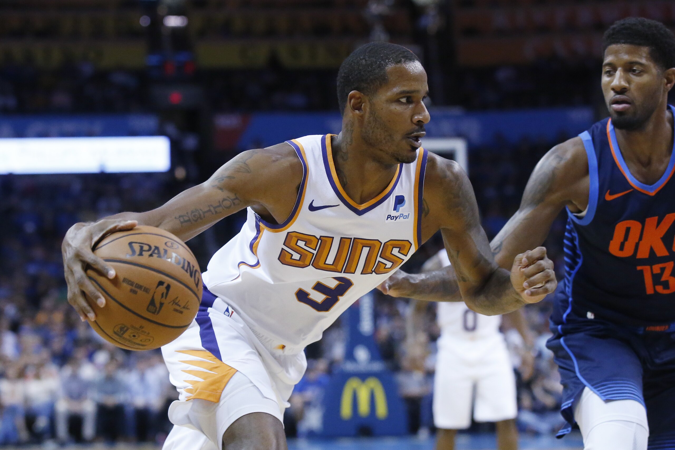 Phoenix Suns forward Trevor Ariza (3) drives around Oklahoma City Thunder forward Paul George (13) in the first half of an NBA basketball game in Oklahoma City, Sunday, Oct. 28, 2018. (AP Photo/Sue Ogrocki)