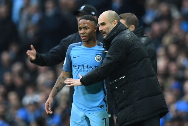 Manchester City's Spanish manager Pep Guardiola (R) speaks with Manchester City's English midfielder Raheem Sterling during the English Premier League football match between Manchester City and Liverpool at the Etihad Stadium in Manchester, north west England, on March 19, 2017. / AFP PHOTO / Paul ELLIS / RESTRICTED TO EDITORIAL USE. No use with unauthorized audio, video, data, fixture lists, club/league logos or 'live' services. Online in-match use limited to 75 images, no video emulation. No use in betting, games or single club/league/player publications.  /         (Photo credit should read PAUL ELLIS/AFP/Getty Images)