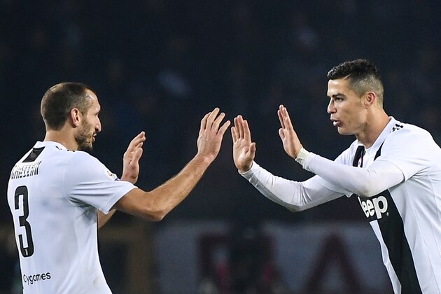 Juventus' Portuguese forward Cristiano Ronaldo (R) celebrates with Juventus' Italian defender Giorgio Chiellini after opening the scoring with a penalty kick during the Italian Serie A football match Torino vs Juventus on December 15, 2018 at the Olympic stadium in Turin. (Photo by Marco BERTORELLO / AFP)        (Photo credit should read MARCO BERTORELLO/AFP/Getty Images)