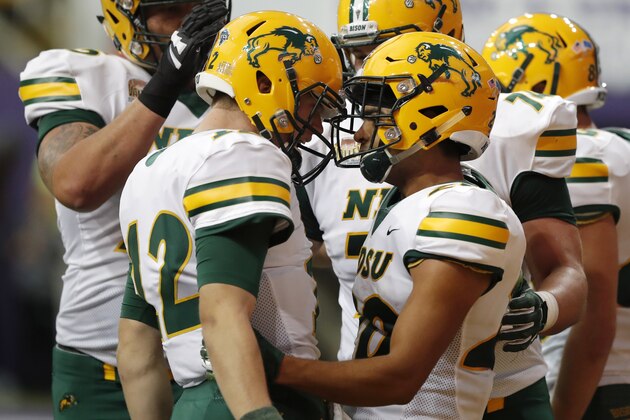 FILE - In this Saturday, Oct. 6, 2018, file photo, North Dakota State wide receiver Darrius Shepherd, right, celebrates with quarterback Easton Stick, left, after catching a 20-yard touchdown pass during the first half of an NCAA college football game against Northern Iowa, in Cedar Falls, Iowa. North Dakota State begins its hunt for its seventh Football Championship Subdivision title in eight years with a familiar ingredient on offense: a high-quality quarterback with plenty of experience in senior Stick. (AP Photo/Charlie Neibergall, File)