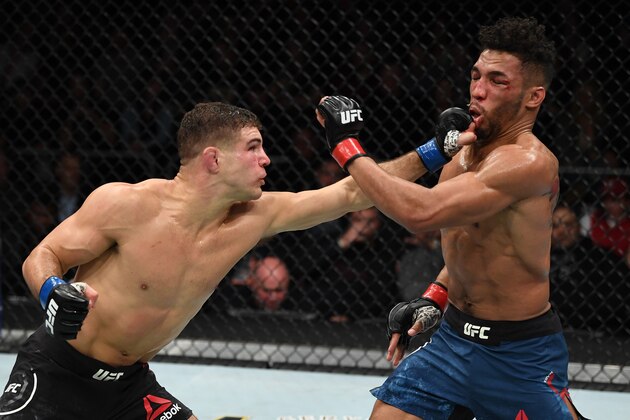 MILWAUKEE, WISCONSIN - DECEMBER 15:  (L-R) Al Iaquinta punches Kevin Lee in their lightweight bout during the UFC Fight Night event at Fiserv Forum on December 15, 2018 in Milwaukee, Wisconsin. (Photo by Jeff Bottari/Zuffa LLC/Zuffa LLC via Getty Images)