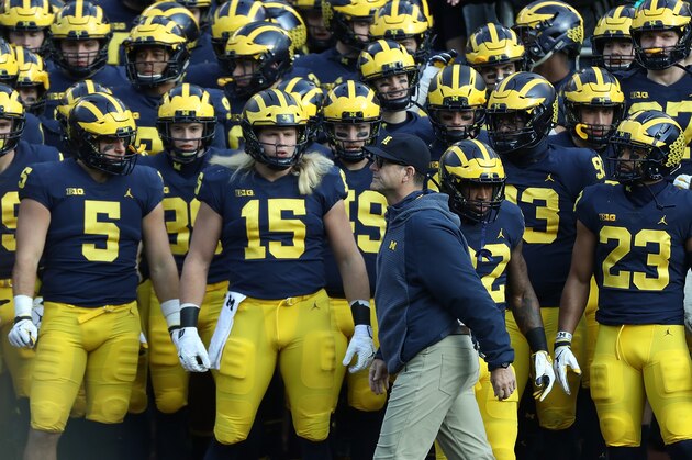 ANN ARBOR, MI - NOVEMBER 03: Head football Coach Jim Harbaugh and Chase Winovich #15 of the Michigan Wolverines gets ready to lead the team onto the field prior to the start of the game against the Penn State Nittany Lions at Michigan Stadium on November 3, 2018 in Ann Arbor, Michigan. Michigan defeated Penn State 42-7. (Photo by Leon Halip/Getty Images)
