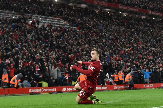 Liverpool's Swiss midfielder Xherdan Shaqiri celebrates after scoring their second goal during the English Premier League football match between Liverpool and Manchester United at Anfield in Liverpool, north west England on December 16, 2018. (Photo by Paul ELLIS / AFP) / RESTRICTED TO EDITORIAL USE. No use with unauthorized audio, video, data, fixture lists, club/league logos or 'live' services. Online in-match use limited to 120 images. An additional 40 images may be used in extra time. No video emulation. Social media in-match use limited to 120 images. An additional 40 images may be used in extra time. No use in betting publications, games or single club/league/player publications. /         (Photo credit should read PAUL ELLIS/AFP/Getty Images)