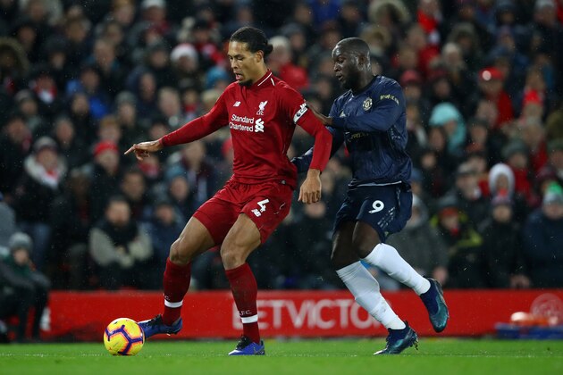 LIVERPOOL, ENGLAND - DECEMBER 16:  Virgil van Dijk of Liverpool battles for posession with Romelu Lukaku of Manchester United during the Premier League match between Liverpool FC and Manchester United at Anfield on December 16, 2018 in Liverpool, United Kingdom.  (Photo by Clive Brunskill/Getty Images)