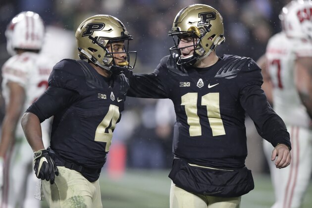 Purdue quarterback David Blough (11) celebrates with wide receiver Rondale Moore (4) during the second half of an NCAA college football game against Wisconsin in West Lafayette, Ind., Saturday, Nov. 17, 2018. Wisconsin defeated Purdue 47-44 in overtime. (AP Photo/Michael Conroy) Purdue quarterback David Blough (11) celebrates with wide receiver Rondale Moore (4) during the second half of an NCAA college football game against Wisconsin in West Lafayette, Ind., Saturday, Nov. 17, 2018. Wisconsin defeated Purdue 47-44 in overtime. (AP Photo/Michael Conroy)