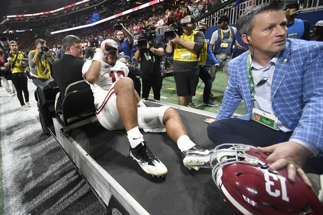 Alabama quarterback Tua Tagovailoa is taken off the field after the Southeastern Conference championship NCAA college football game between Georgia and Alabama, Saturday, Dec. 1, 2018, in Atlanta. Alabama won 35-28. (AP Photo/John Amis)