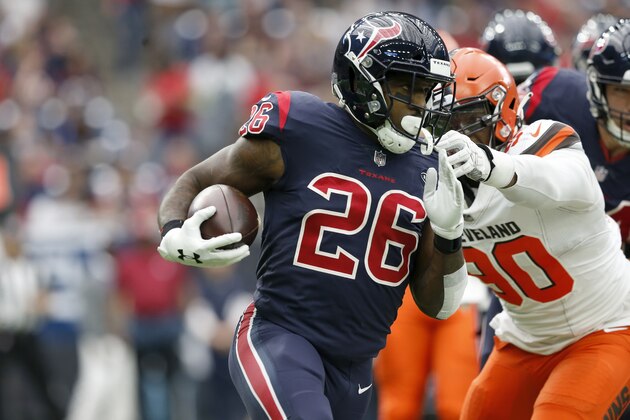 HOUSTON, TX - DECEMBER 02:  Lamar Miller #26 of the Houston Texans rushes the ball defended by Emmanuel Ogbah #90 of the Cleveland Browns in the first quarter at NRG Stadium on December 2, 2018 in Houston, Texas.  (Photo by Tim Warner/Getty Images)