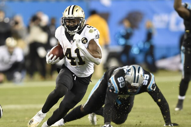 New Orleans Saints' Alvin Kamara (41) runs past Carolina Panthers' Kawann Short (99) in the second half of an NFL football game in Charlotte, N.C., Monday, Dec. 17, 2018. (AP Photo/Mike McCarn)