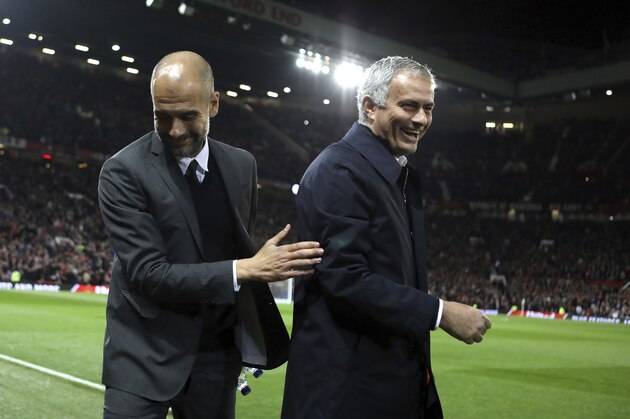 FILE - In this Wednesday, Oct. 26, 2016 file photo, Manchester City's manager Pep Guardiola, left, and Manchester United's manager Jose Mourinho smile ahead of their English League Cup soccer match at Old Trafford stadium in Manchester. There were handshakes, smiles, even an embrace, in the first two head-to-heads between Pep Guardiola and Jose Mourinho in English soccer. With the pressure and tension ramped up a notch for the third Manchester derby of the season, will the two coaching adversaries be able to retain their new-found cordiality on Thursday, April 27? (AP Photo/Dave Thompson, file)