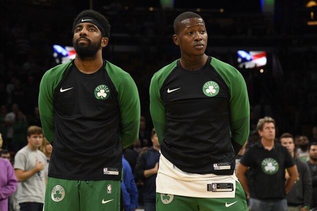 BOSTON, MA - SEPTEMBER 30:  Kyrie Irving #11 Terry Rozier #12 of the Boston Celtics look on during the national anthem against the Charlotte Hornets during a preseason game on September 30, 2018 at the TD Garden in Boston, Massachusetts. NOTE TO USER: User expressly acknowledges and agrees that, by downloading and or using this photograph, User is consenting to the terms and conditions of the Getty Images License Agreement. Mandatory Copyright Notice: Copyright 2018 NBAE  (Photo by Brian Babineau/NBAE via Getty Images)