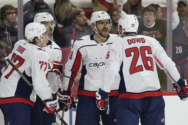 Washington Capitals' Alex Ovechkin (8), of Russia, celebrates his goal against the Carolina Hurricanes with T.J. Oshie (77), Nic Dowd (26) and Jonas Siegenthaler, of the Czech Republic, during the second period of an NHL hockey game in Raleigh, N.C., Friday, Dec. 14, 2018. (AP Photo/Gerry Broome)