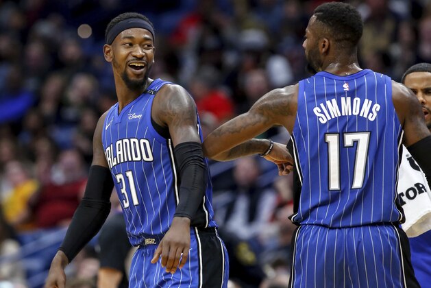 Orlando Magic guard Terrence Ross (31) and Orlando Magic forward Jonathon Simmons (17) celebrate a basket against the New Orleans Pelicans in the second half of an NBA basketball game in New Orleans, Monday, Oct. 30, 2017. The Magic won 115-99. (AP Photo/Scott Threlkeld)