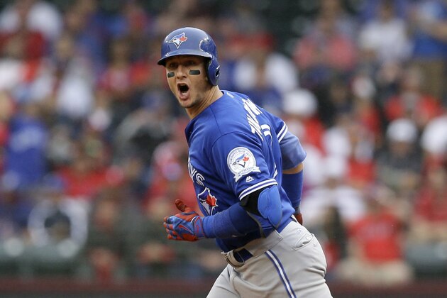 Toronto Blue Jays' Troy Tulowitzki celebrates as he rounds the bases after hitting a two-run home run in the second inning of Game 2 of baseball's American League Division Series, Friday, Oct. 7, 2016, in Arlington, Texas. Teammate Jose Bautista also scored. (AP Photo/LM Otero)