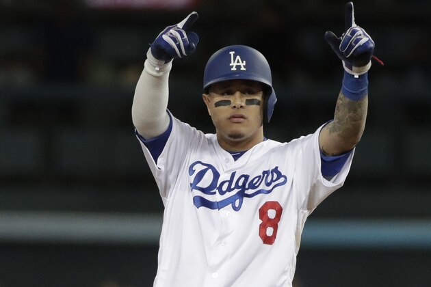 Los Angeles Dodgers' Manny Machado reacts after hitting a double during the first inning of Game 3 of the National League Championship Series baseball game Monday, Oct. 15, 2018, in Los Angeles. (AP Photo/Jae Hong)