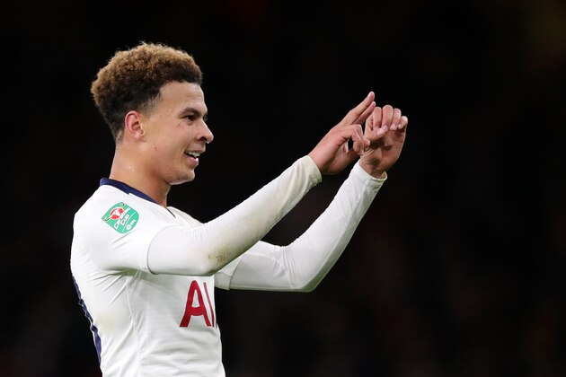 LONDON, ENGLAND - DECEMBER 19: Dele Alli of Tottenham Hotspur gestures the score to the crowd after being hit by a water bottle during the Carabao Cup Quarter Final match between Arsenal and Tottenham Hotspur at Emirates Stadium on December 19, 2018 in London, United Kingdom.  (Photo by Alex Morton/Getty Images)