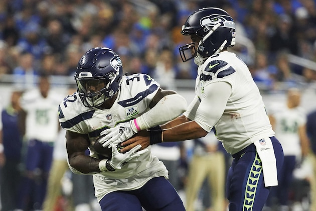 Seattle Seahawks quarterback Russell Wilson (3) hands off to running back Chris Carson (32) against the Detroit Lions during an NFL football game at Ford Field in Detroit, Sunday, Oct. 28, 2018. (AP Photo/Rick Osentoski)