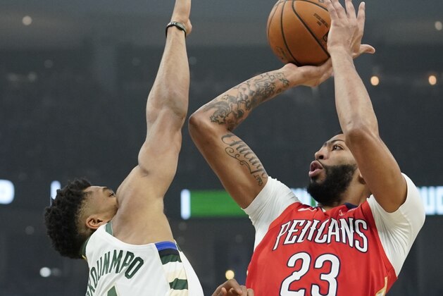 New Orleans Pelicans' Anthony Davis shoots over Milwaukee Bucks' Giannis Antetokounmpo during the first half of an NBA basketball game Wednesday, Dec. 19, 2018, in Milwaukee. (AP Photo/Morry Gash)