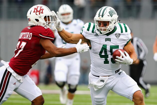 HADLEY, MA - SEPTEMBER 30:  A.J. Ouellette #45 of the Ohio Bobcats stiff arms Jesse Monteiro #27 of the Massachusetts Minutemen during the first half of their game at Warren McGuirk Alumni Stadium on September 30, 2017 in Hadley, Massachusetts.  (Photo by Tim Bradbury/Getty Images)