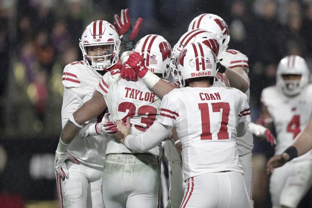 Wisconsin running back Jonathan Taylor (23) celebrates his game-winning touchdown against Purdue during overtime of an NCAA college football game in West Lafayette, Ind., Saturday, Nov. 17, 2018. Wisconsin defeated Purdue 47-44 in overtime. (AP Photo/Michael Conroy)