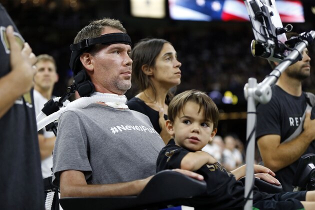 Former New Orleans Saints player Steve Gleason with with his son Rivers, and wife Michel Varisco Gleason, during the National Anthem, before an NFL football game against the Atlanta Falcons in New Orleans, Monday, Sept. 26, 2016. (AP Photo/Gerald Herbert)