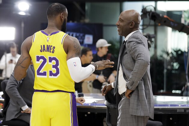 Los Angeles Lakers' LeBron James (23) chats with former Lakers player James Worthy during media day at the NBA basketball team's practice facility Monday, Sept. 24, 2018, in El Segundo, Calif. (AP Photo/Marcio Jose Sanchez)
