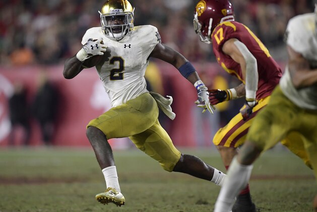 Notre Dame running back Dexter Williams, left, carries the ball as Southern California cornerback Chase Williams defends during the second half of an NCAA college football game Saturday, Nov. 24, 2018, in Los Angeles. Notre Dame won 24-17. (AP Photo/Mark J. Terrill)