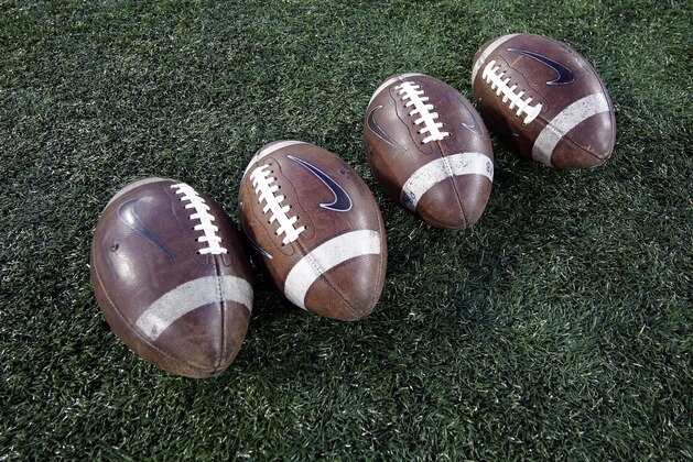Footballs sit on the field before an NCAA college football game between Memphis and Houston Saturday, Nov. 14, 2015, in Houston. (AP Photo/David J. Phillip)
