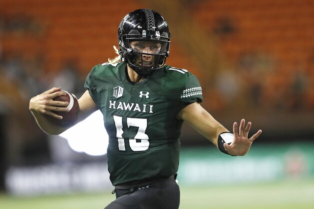 Hawaii quarterback Cole McDonald (13) gains yards over Duquesne during the fourth quarter of an NCAA college football game Saturday, Sept. 22, 2018, in Honolulu. (AP Photo/Marco Garcia)