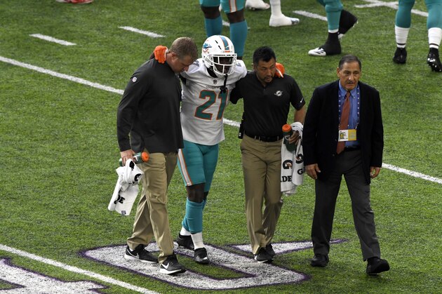 MINNEAPOLIS, MN - DECEMBER 16: Frank Gore #21 of the Miami Dolphins is helped off the field by team trainers in the second quarter of the game against the Minnesota Vikings at U.S. Bank Stadium on December 16, 2018 in Minneapolis, Minnesota. (Photo by Hannah Foslien/Getty Images)
