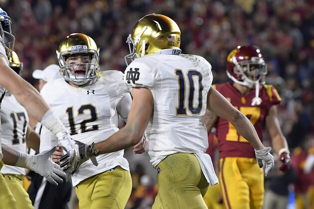 Notre Dame wide receiver Chris Finke, foreground, celebrates his touchdown with quarterback Ian Book (12) during the first half of an NCAA college football game against Southern California on Saturday, Nov. 24, 2018, in Los Angeles. (AP Photo/Mark J. Terrill)