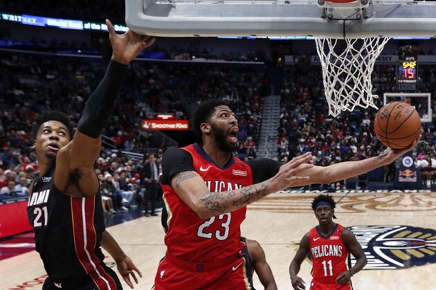 New Orleans Pelicans forward Anthony Davis (23) goes to the basket against Miami Heat center Hassan Whiteside (21) in the first half of an NBA basketball game in New Orleans, Sunday, Dec. 16, 2018. The Heat won 102-96. (AP Photo/Gerald Herbert)