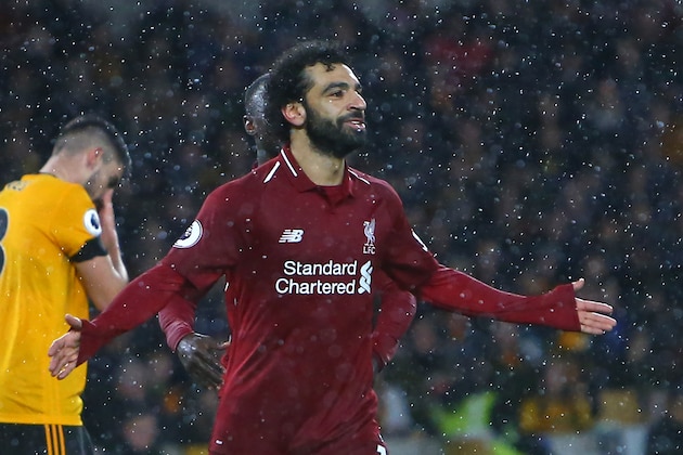 Liverpool's Egyptian midfielder Mohamed Salah celebrates after scoring the opening goal of the English Premier League football match between Wolverhampton Wanderers and Liverpool at the Molineux stadium in Wolverhampton, central England on December 21, 2018. (Photo by Geoff CADDICK / AFP) / RESTRICTED TO EDITORIAL USE. No use with unauthorized audio, video, data, fixture lists, club/league logos or 'live' services. Online in-match use limited to 120 images. An additional 40 images may be used in extra time. No video emulation. Social media in-match use limited to 120 images. An additional 40 images may be used in extra time. No use in betting publications, games or single club/league/player publications. / (Photo credit should read GEOFF CADDICK/AFP/Getty Images) Liverpool's Egyptian midfielder Mohamed Salah celebrates after scoring the opening goal of the English Premier League football match between Wolverhampton Wanderers and Liverpool at the Molineux stadium in Wolverhampton, central England on December 21, 2018. (Photo by Geoff CADDICK / AFP) / RESTRICTED TO EDITORIAL USE. No use with unauthorized audio, video, data, fixture lists, club/league logos or 'live' services. Online in-match use limited to 120 images. An additional 40 images may be used in extra time. No video emulation. Social media in-match use limited to 120 images. An additional 40 images may be used in extra time. No use in betting publications, games or single club/league/player publications. / (Photo credit should read GEOFF CADDICK/AFP/Getty Images)