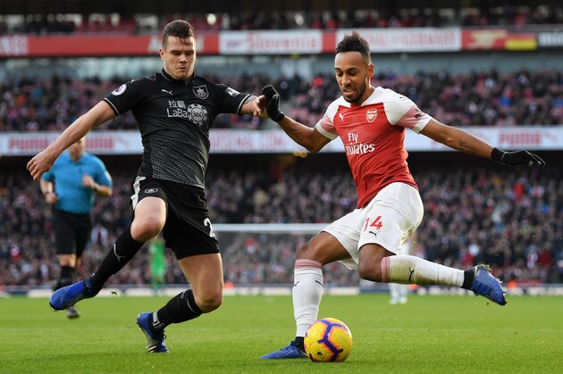 LONDON, ENGLAND - DECEMBER 22:  Pierre-Emerick Aubameyang of Arsenal is challenged by Kevin Long of Burnley during the Premier League match between Arsenal FC and Burnley FC at Emirates Stadium on December 22, 2018 in London, United Kingdom.  (Photo by Shaun Botterill/Getty Images)