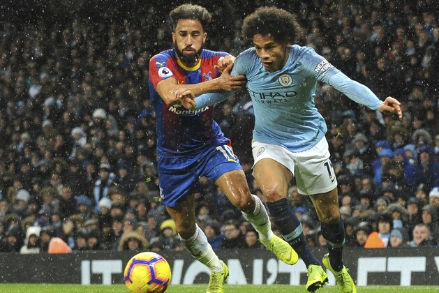 Crystal Palace's Andros Townsend, left, and Manchester City's Leroy Sane challenge for the ball during the English Premier League soccer match between Manchester City and Crystal Palace at Etihad stadium in Manchester, England, Saturday, Dec. 22, 2018. (AP Photo/Rui Vieira)