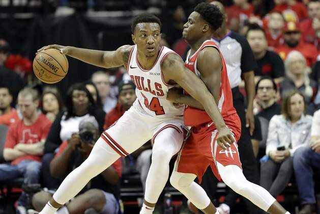 Chicago Bulls' Wendell Carter Jr. (34) works for position as Houston Rockets' Danuel House Jr. defends during the first half of an NBA basketball game Saturday, Dec. 1, 2018, in Houston. (AP Photo/David J. Phillip)