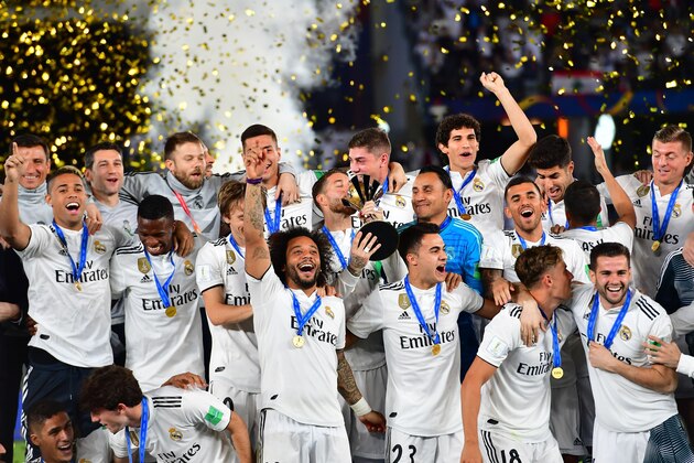 Real Madrid's players celebrate with the trophy after winning the FIFA Club World Cup final football match Spain's Real Madrid vs Abu Dhabi's Al Ain at the Zayed Sports City Stadium in Abu Dhabi, the capital of the United Arab Emirates, on December 22, 2018. (Photo by Giuseppe CACACE / AFP)        (Photo credit should read GIUSEPPE CACACE/AFP/Getty Images)
