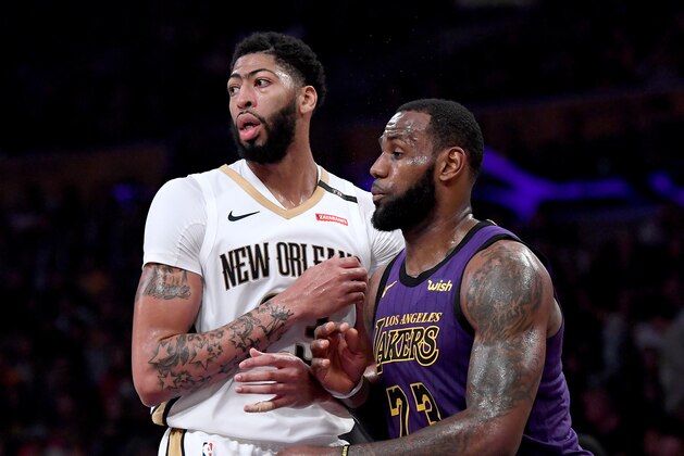 LOS ANGELES, CALIFORNIA - DECEMBER 21:  LeBron James #23 of the Los Angeles Lakers guards Anthony Davis #23 of the New Orleans Pelicans during a 112-104 Laker win at Staples Center on December 21, 2018 in Los Angeles, California.  NOTE TO USER: User expressly acknowledges and agrees that, by downloading and or using this photograph, User is consenting to the terms and conditions of the Getty Images License Agreement. (Photo by Harry How/Getty Images)
