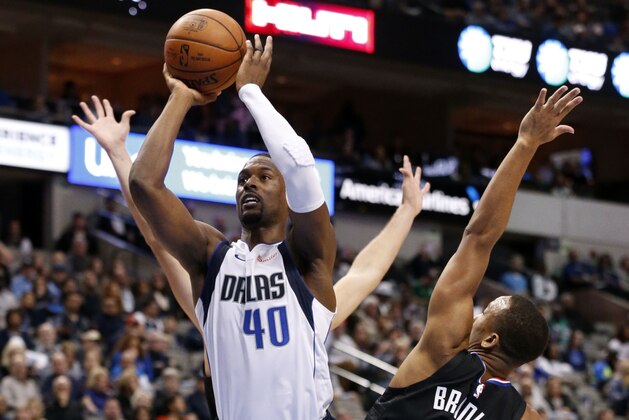 Dallas Mavericks forward Harrison Barnes (40) gets a shot off while being defended by Los Angeles Clippers guard Avery Bradley (11) during the second half of an NBA basketball game in Dallas, Sunday, Dec. 2, 2018. Dallas won 114-110. (AP Photo/Michael Ainsworth)