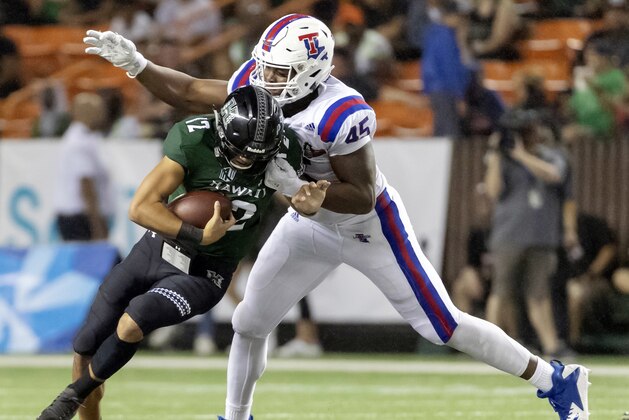 Louisiana Tech defensive end Jaylon Ferguson (45) sacks Hawaii quarterback Chevan Cordeiro (12) in the first half of the Hawaii Bowl NCAA college football game, Saturday, Dec. 22, 2018, in Honolulu. (AP Photo/Eugene Tanner)