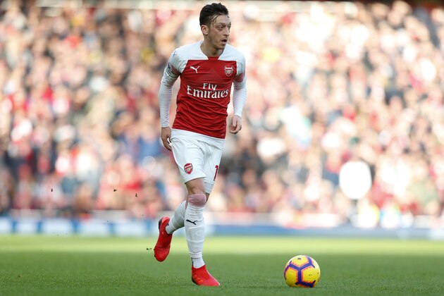 Arsenal's German midfielder Mesut Ozil runs with the ball during the English Premier League football match between Arsenal and Burnley at the Emirates Stadium in London on December 22, 2018. (Photo by Ian KINGTON / AFP) / RESTRICTED TO EDITORIAL USE. No use with unauthorized audio, video, data, fixture lists, club/league logos or 'live' services. Online in-match use limited to 120 images. An additional 40 images may be used in extra time. No video emulation. Social media in-match use limited to 120 images. An additional 40 images may be used in extra time. No use in betting publications, games or single club/league/player publications. /         (Photo credit should read IAN KINGTON/AFP/Getty Images)