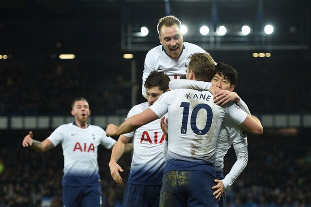 Tottenham Hotspur's English striker Harry Kane (C) with Tottenham Hotspur's South Korean striker Son Heung-Min (R) and Tottenham Hotspur's Danish midfielder Christian Eriksen (top) celebrates scoring their sixth goal during the English Premier League football match between Everton and Tottenham Hotspur at Goodison Park in Liverpool, north west England on December 23, 2018. (Photo by Oli SCARFF / AFP) / RESTRICTED TO EDITORIAL USE. No use with unauthorized audio, video, data, fixture lists, club/league logos or 'live' services. Online in-match use limited to 120 images. An additional 40 images may be used in extra time. No video emulation. Social media in-match use limited to 120 images. An additional 40 images may be used in extra time. No use in betting publications, games or single club/league/player publications. /         (Photo credit should read OLI SCARFF/AFP/Getty Images)
