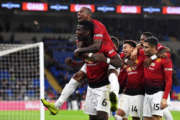 CARDIFF, WALES - DECEMBER 22:  Paul Pogba of Manchester United and Ashley Young of Manchester United celebrate as teammate Jesse Lingard scores their team's fifth goal during the Premier League match between Cardiff City and Manchester United at Cardiff City Stadium on December 22, 2018 in Cardiff, United Kingdom.  (Photo by Stu Forster/Getty Images)